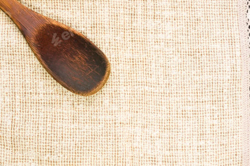 Preview: Rustic Coarse Canvas Fabric And A Worn Wooden Spoon, Close-Up, Background