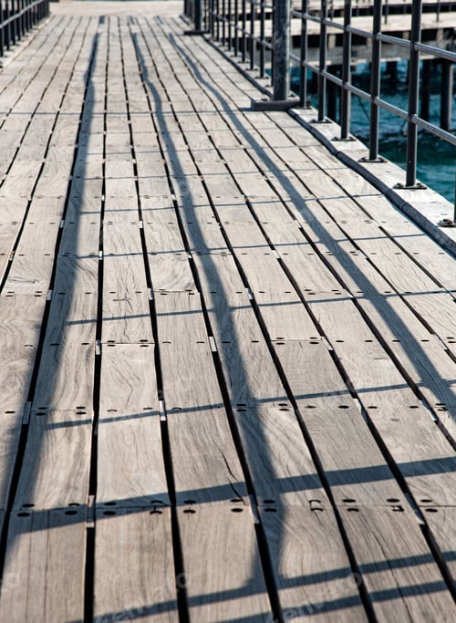 Preview: Lines And Shadows On An Empty Wooden Pier Leading To The End