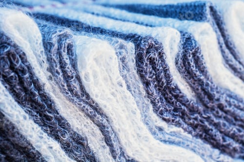 Preview: Knitted White And Gray Fabric Close Up. Winter Wear Knitted Fabric Texture.