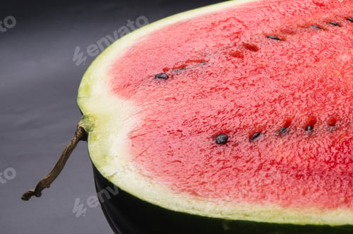 Preview: Half Of Ripe Watermelon On A Black Background