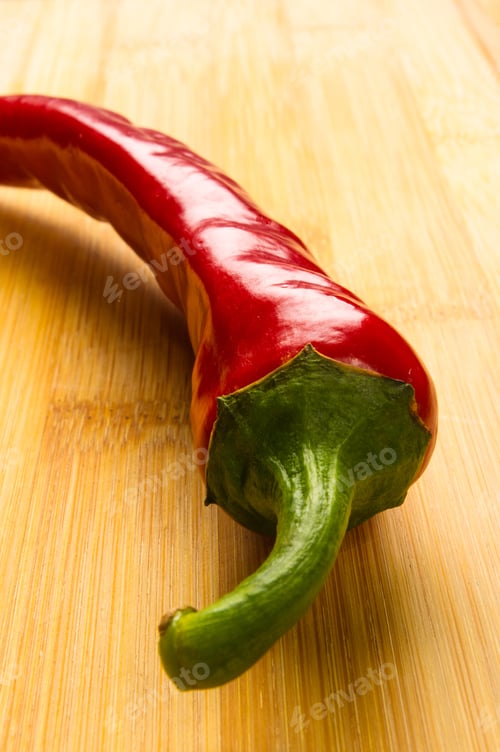 Preview: Red Chili Pepper On A Wooden Background