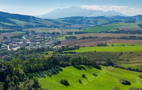 Preview: Rural Area Around The Town. Grassy Hill And Agricultural Fields. High Tatra Mountain Ridge In The