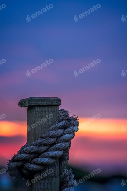 Preview: Thick Rope Tied Around A Wooden Fence Plank And The Beautiful Sky At Sunset Over The Cornish Coast