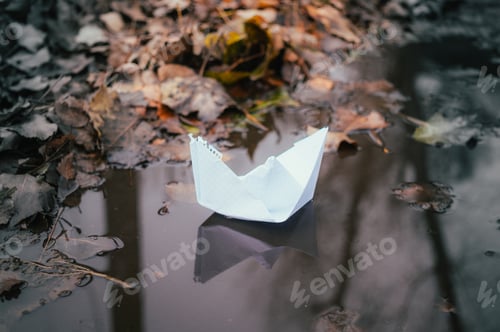 Preview: White Paper Boat On A City Puddle Background