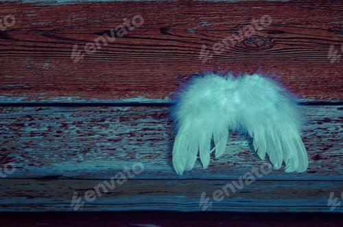 Preview: White Soft Feather Wings Decoration Against Wooden Background