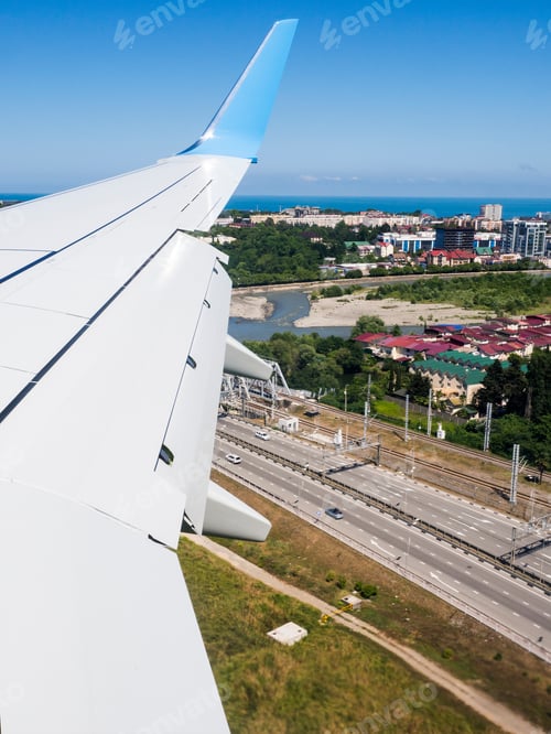 Preview: View Through Airplane Porthole With Cultivated Fields, Blue Sky, Light Clouds And Part Of Airplane