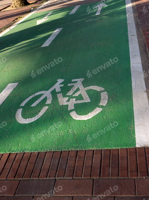 Preview: White Arrow In Green Bicycle Road Sign In Barcelona
