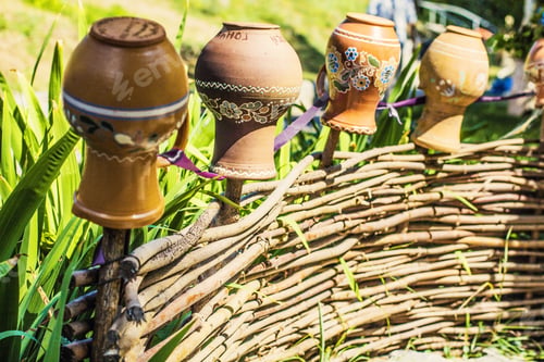 Preview: Ukrainian Village. Wooden Fence, Clay Pitchers Hanging On Wooden Fence. Ukrainian Pottery.