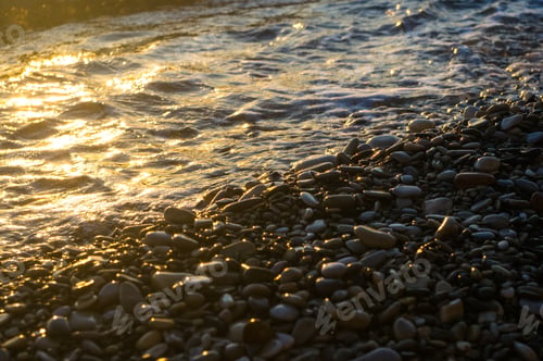 Preview: Sea Pebble Beach With Multicoloured Stones, Transparent Waves With Foam, On A Warm Evening