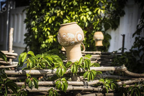 Preview: Ukrainian Village. Wooden Fence, Clay Pitchers Hanging On Wooden Fence. Ukrainian Pottery.