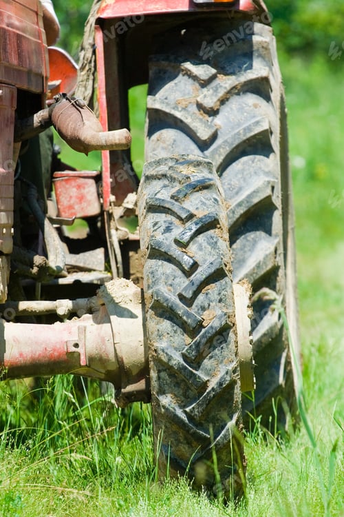 Preview: Red Tractor Plowing In An Orchard