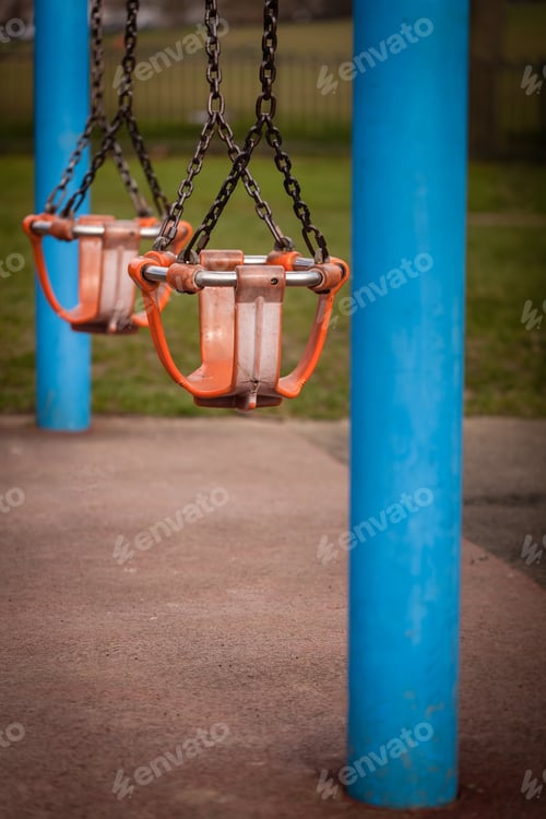 Preview: Two Empty Swings In An Outdoor Playground