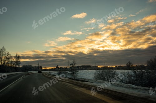 Preview: Snow And Ice Covered Road In Countryside In Winter With Tire Tracks