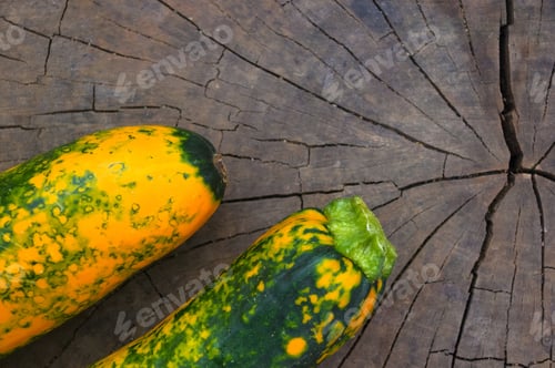Preview: Unusual Green-Orange Zucchini On An Old Wooden Background