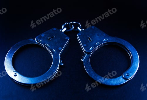 Preview: Toned Photo Of Handcuffs On The Dark Background Closeup