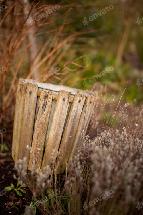 Preview: Old Overgrown Rubbish Bin In The Park