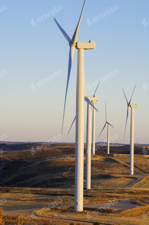 Preview: View At Dusk Of A Group Of Modern Windmills For Electricity Production