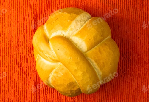 Preview: Fresh Braided Loaf Of White Wheat Bread On An Orange Napkin