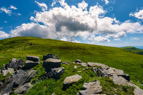 Preview: Huge Cloud Rising Behind The Hill. Gorgeous Mountain Landscape With Boulders On Grassy Slopes