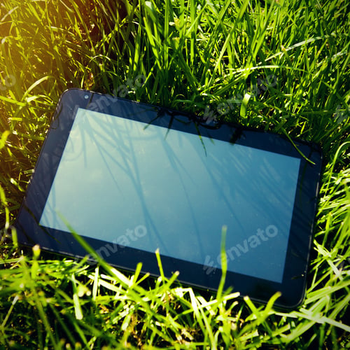 Preview: Toned Photo Of Tablet Computer On The Green Grass Closeup
