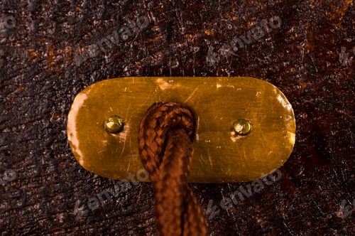 Preview: Rope Fastened with Metal Plate on Wooden Surface