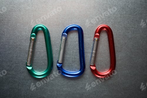 Preview: Small Carabiners On A Metal Table.