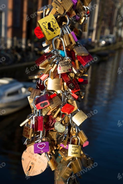 Preview: Lovers Attaching A Love Lock With Date And Name Written On It, Onto A Bridge To Remember Their Love