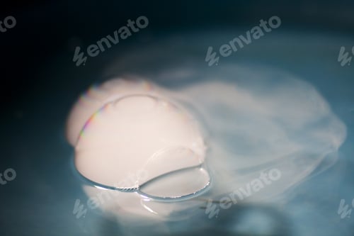Preview: Abstract Shot With Big Soap Bubbles On A Water Surface With Smoke Inside. Image Has Grain Texture
