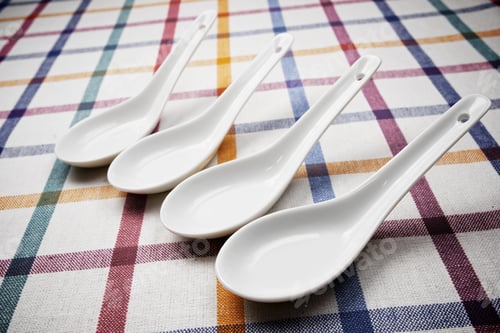 Preview: Small White Spoons On A White Tablecloth