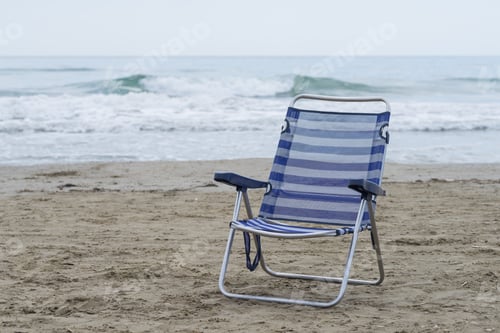 Beach Chair on Sandy Beach by Ocean