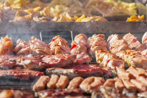 Preview: Different Kind On Grilled Meat, Sausages And Fried Potatoes With Smoke And Steam From De Grill
