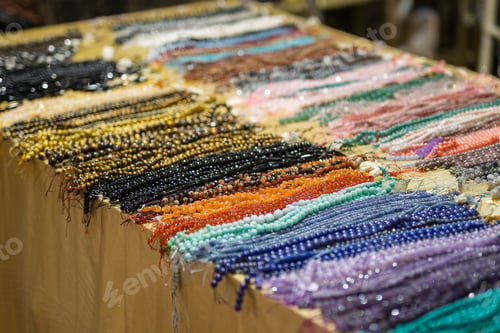 Preview: Heap Of Necklaces With Coloured Beads Displayed On A Table.
