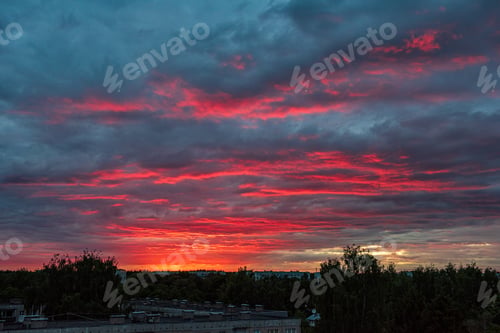 Preview: Dramatic Red Sunset Colors In The Sky Above Trees And Fields. Summer Sunset In Latvia