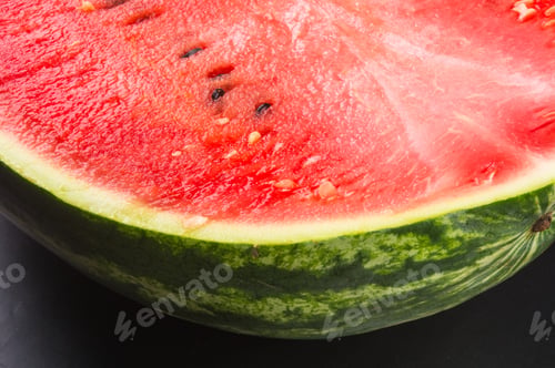 Preview: Half Of Ripe Watermelon On A Black Background