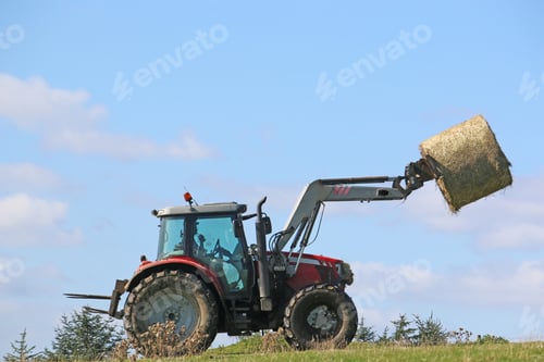 Preview: Tractor Lifting A Hay Bale