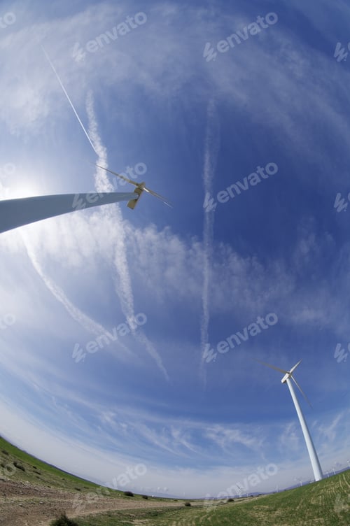 Preview: Windmills In A Field With Blue Sky