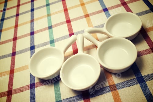 Preview: Small White Spoons On A White Tablecloth