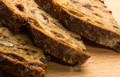 Preview: Slices Of Malt Bread Handmade With Nuts, Raisins And Cranberries On Wooden Background
