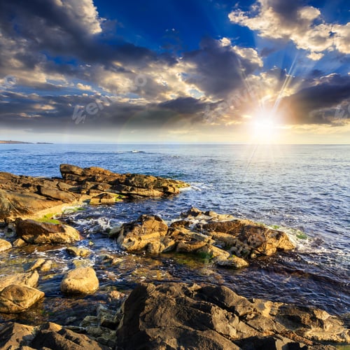 Preview: Sea Wave Attacks The Boulders And Is Broken About Them At Sunset