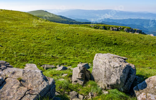 Preview: Mountain Summer Landscape. Meadow With Huge Rocks Among The Grass On Top Of The Hillside Near The
