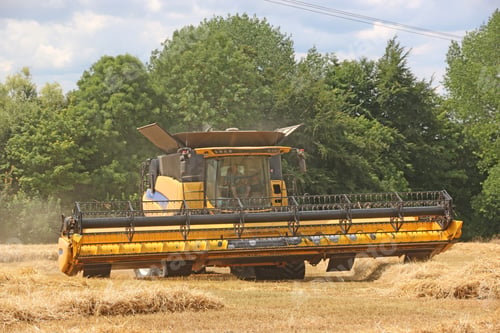 Preview: Combine Harvester At Work In A Field At Harvest