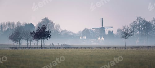 Preview: Houses And Historic Dutch Windmill In Misty Countryside. Geesteren, Achterhoek, Gelderland.
