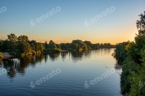 Preview: Reflections Of Shore Trees In The Calm Water Of A Lake In Countryside
