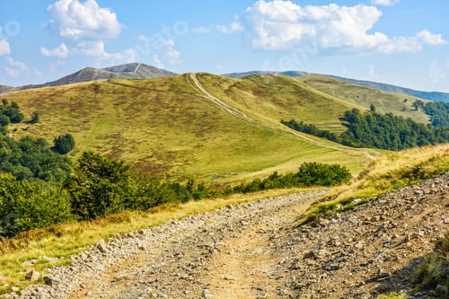 Preview: Winding Road Through Large Meadows On The Hillside Of Mountain Range