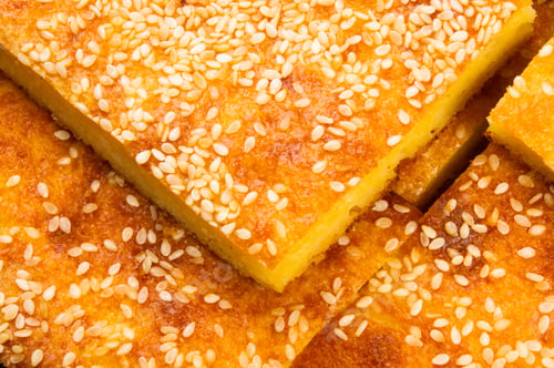 Preview: Slice Of Cheesecake With Sesame Seeds On A Black Background