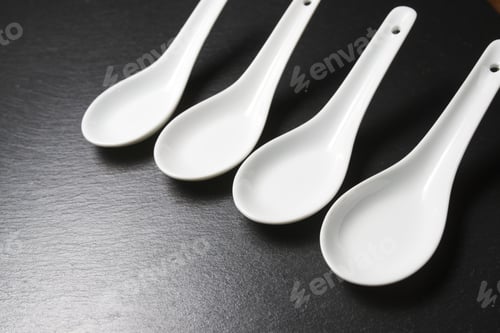 Preview: Small White Spoons On A Table Slate
