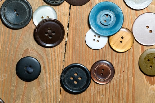 Preview: Buttons Lying On Old Wooden Floor. Abstract Background Of Buttons.