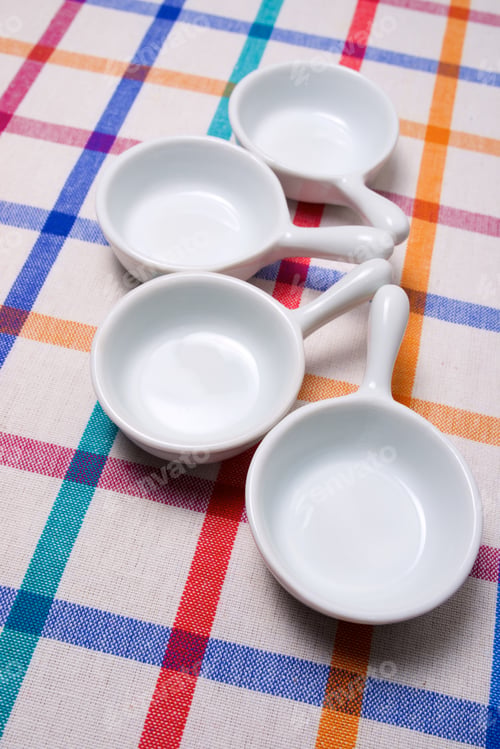 Preview: Small White Spoons On A White Tablecloth