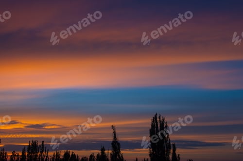 Preview: Landscape With Dramatic Light - Orange Clouds And The Outline Of Trees At Sunset