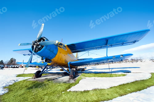 Preview: Old Airplanes Parked On A Meadow With Snow In A Sunny Day